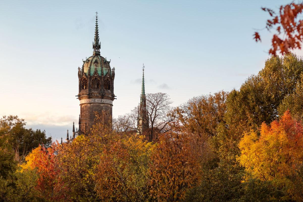 The Castle Church in Wittenberg among autumn trees
