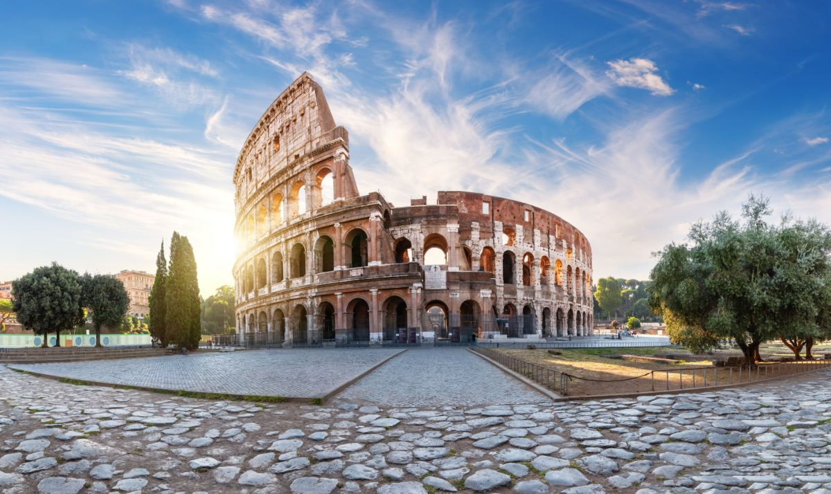 The Colosseum in Rome under a blue sky