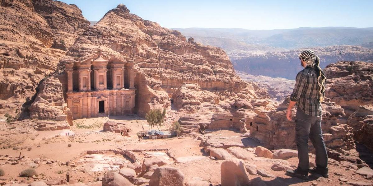 A traveler looking out over the Monastery at Petra